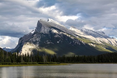 Well-known mountain by the sea rises strikingly into the cloudy sky