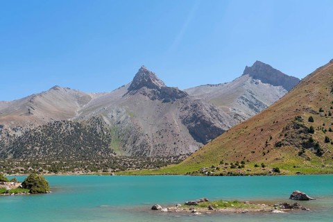 The Pamir range view and peaceful campsite on Kulikalon lake in Fann mountains in Tajikistan.