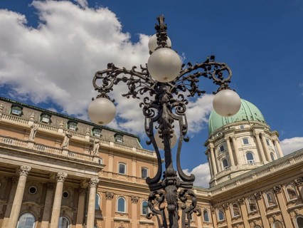 Historic lantern and building with green dome in Budapest under a cloudy sky, budapest, danube,