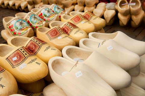 Many different Dutch wooden clogs at the market in Holland