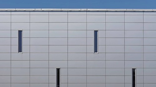 Grey metal panels at commercial building exterior