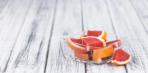 Chopped Grapefruits (selective focus) on a vintage background as detailed close-up shot