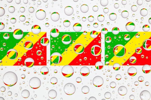 Flags of Congo behind a glass covered with raindrops. 3D illustration