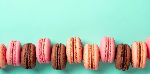 Macarons banner with copy space. Colorful french macarons or macaroons on blue turquoise background