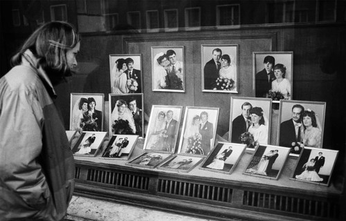 05/03/1983 GDR district of Cottbus town of Spremberg. Young woman looks into the shop window of the