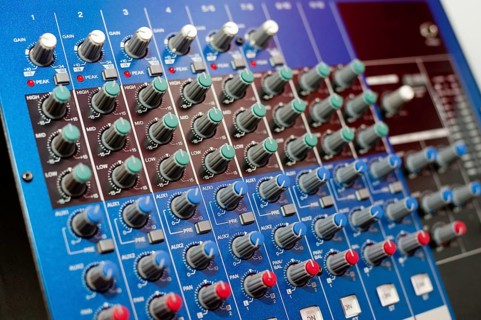 An audio control console, closeup, narrow focus