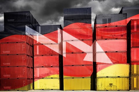 Stacked containers in German national colours with downward pointing arrow, symbolic photo economic