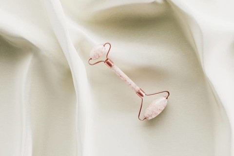 Quartz beauty face roller on white silk 3D rendering