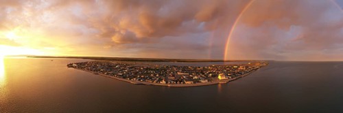 Rain falls as sun shines in the middle of the night at Kotzebue Alaska creating a beautiful