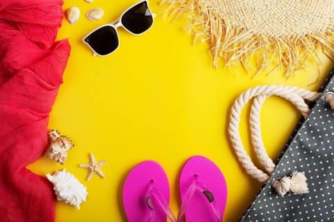 Straw hat sunglesses flip flops beach bag on yellow background vacation travel planning mockup