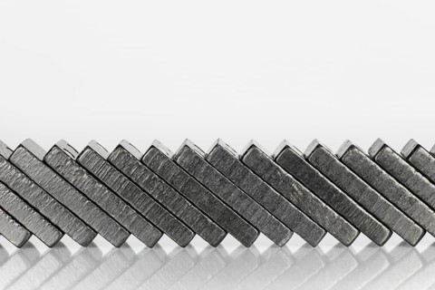 Composition of lying black domino bricks with white dots