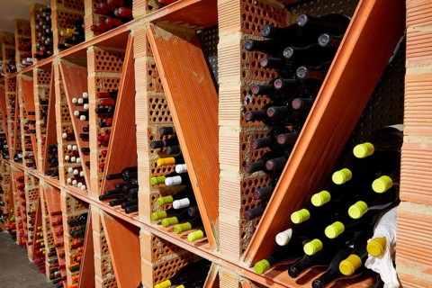 Wine Cellar from Mediterranean with bottles stacked in rows