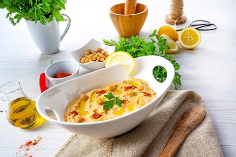 Hummus paste with lemon and chilli on a white background