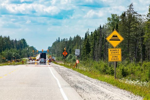 Temporary condition road warning signs on the roadside before road work zone, rumble strips on a