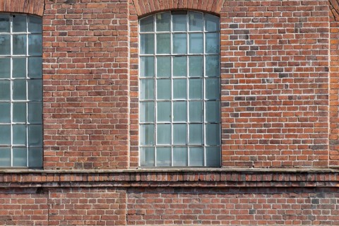 Three large mullioned windows in a uniform brick wall, Bottrop, North Rhine-Westphalia, Germany,