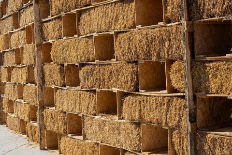 Harvesting in agriculture bales of hay are stacked in large stacks