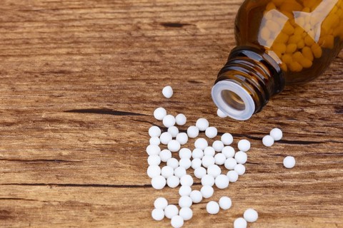 Homeopathy medicine on wooden background
