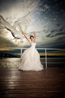 Pretty lady in a wedding dress on deck