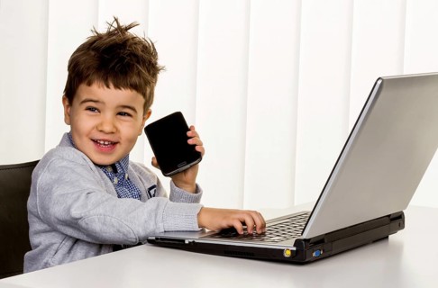 Little boy at the laptop, symbol for internet, e-commerce, consumer behaviour