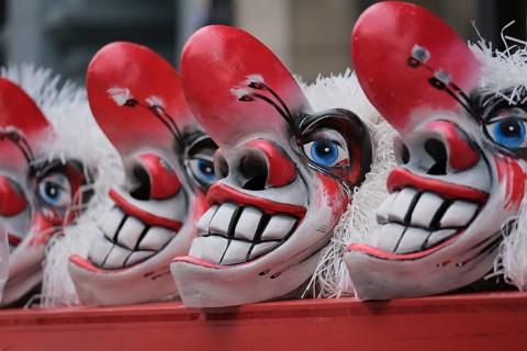 Clown masks with large teeth and blue eye accent, cheerful and scary impression