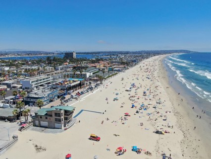 Aerial view of people at the beach during blue summer day. Pacific Beach in San Diego, California