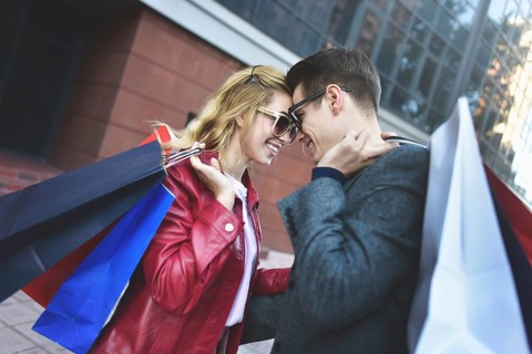 Portrait of a couple with shopping bags in the city.People, sale, love and happiness concept