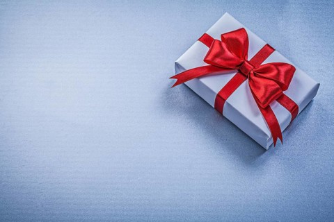 Present with ribbon on blue background holidays concept