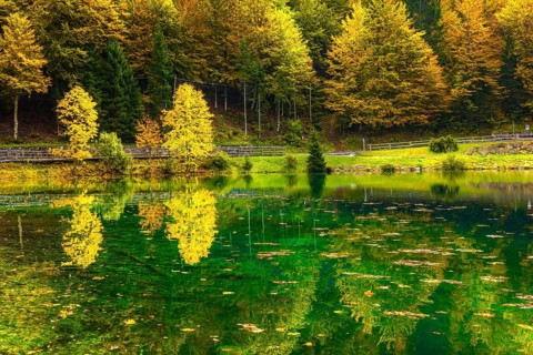 The quiet lake Lago de Fusine. Concept of cultural and ecological tourism. High water after a rain.