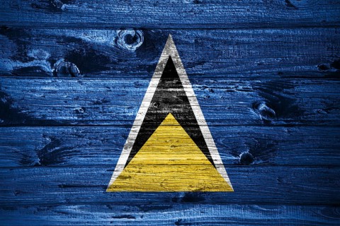 Saint Lucia flag on wooden planks background wood flag