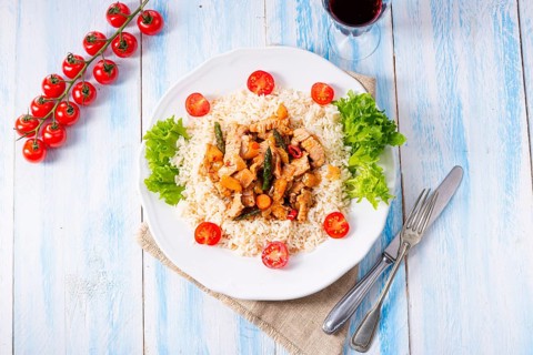 Turkey fricassee on rice with asparagus and peppers