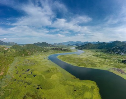 Aerial view of Rijeka Crnojevica, beautiful river between mountains flowing into Skadar Lake,