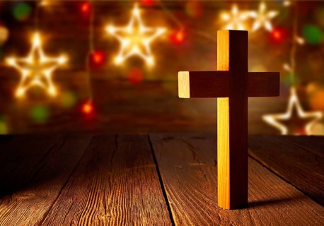 Christian wood cross on Christmas stars wooden background