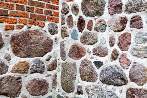 Old stone wall made of erratics rocks and bricks, Church of St. Urbanus, Dorum, Lower Saxony,