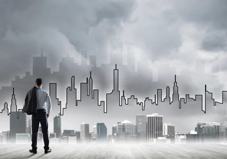 Motivation and inspiration concept with modern cityscape and businessman observing it