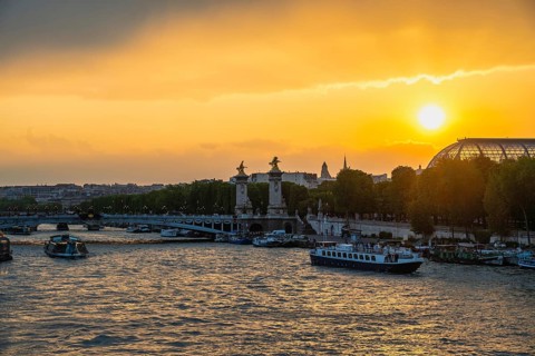 Paris France, city skyline sunset at Seine River with Pont Alexandre III bridge and Grand Palais