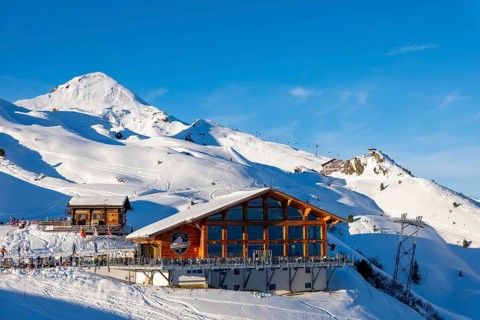 Ski Slope with Overhead Cable Car and Restaurant at 2000 Meters High Up and Mountain Peak in a