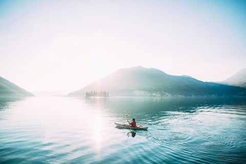 Kayaks in the lake. Tourists kayaking on the Bay of Kotor, near the town of Perast in Montenegro.