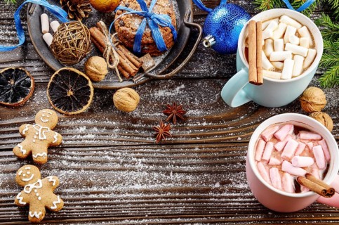 Flat lay Christmas background of two mugs of hot chocolate with marshmallows, spruce branch and