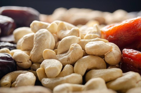 Closeup view at cashew nuts on kitchen table. Vegetarian food concept