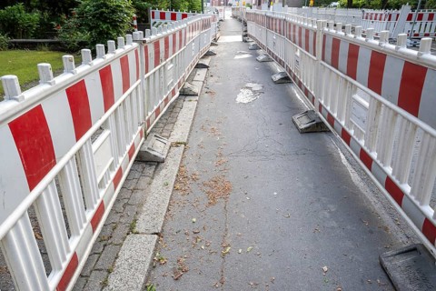 Construction site barrier of a road with a sidewalk