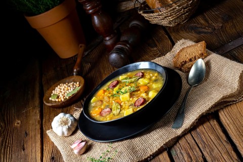 Rustic pea soup with bacon and sausage