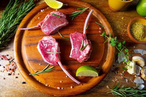 Raw fresh lamb chops Wooden chopping board