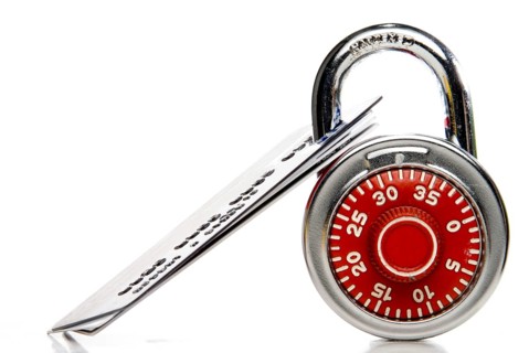 A set of credit cards secured with a padlock