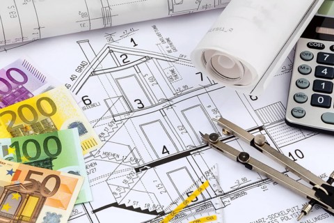 An architect's construction plan with a pocket calculator and euro money. Symbolic photo for