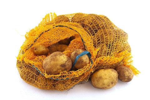 Plastic bag full potatoes isolated over white background