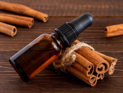 Cinnamon sticks and bottle with cinnamon essential oil