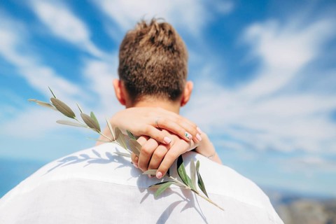 Olive branch in female hands. Hands of the bride. Wedding in Montenegro