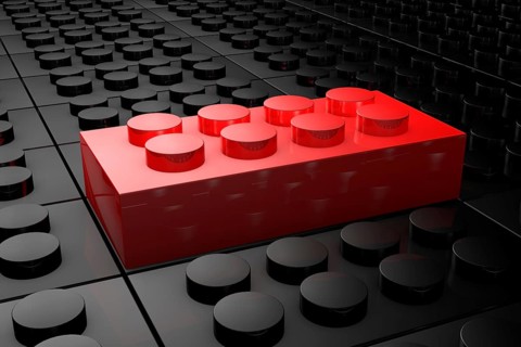 3D rendering red toy bricks standing out from crowd of black toy bricks . Leadership, independence,