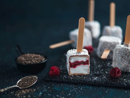 Homemade raw lamington ice cream pops on dark background. Australian sweet dessert lamington with