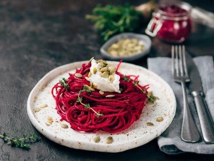 Beetroot pesto or hummus. Homemade beet pesto sauce in glass jar and fresh thyme on dark black